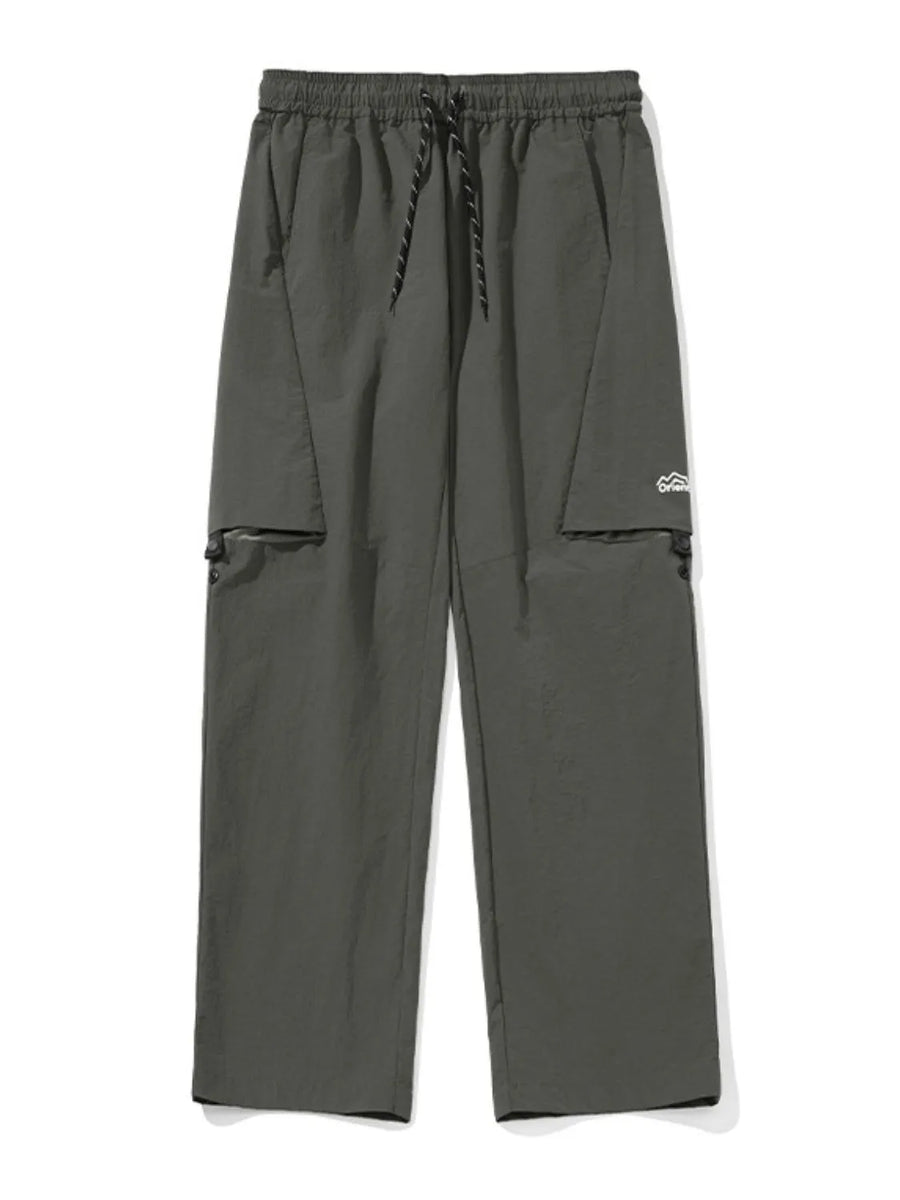 Gray cargo pants with zip-off legs and drawstring waist.