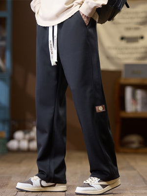 pants in black featuring drawstring waist and loose fit