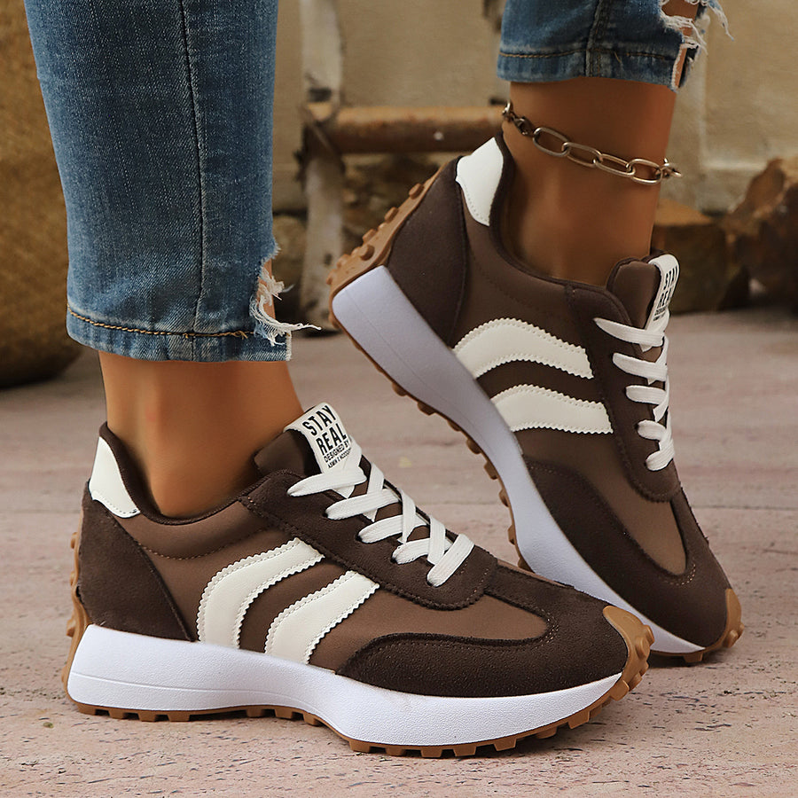 Green sneakers featuring round toe and striped