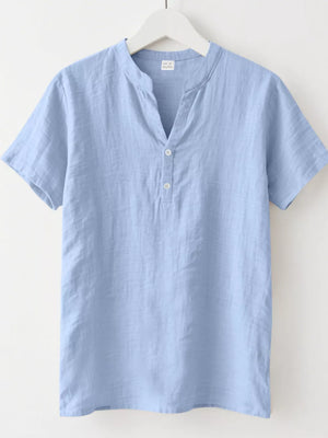 Light blue relaxed-fit men's short sleeve overshirt with band collar and button detail.