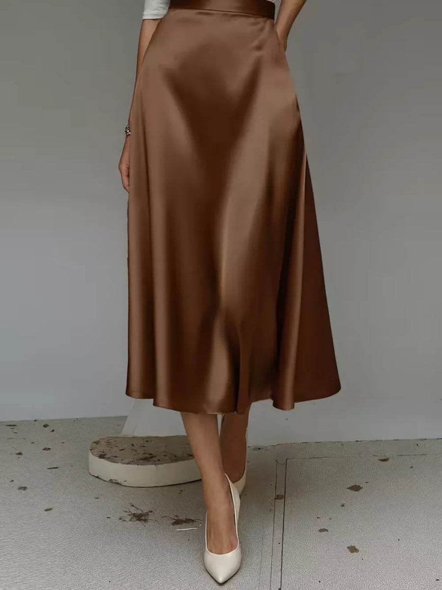 Elegant A-line satin skirt in dark brown with pockets, midi length.