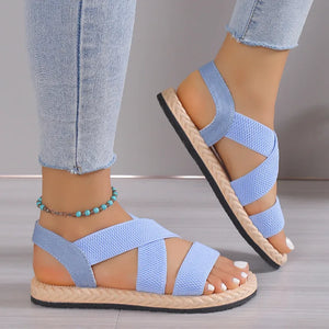 Pastel blue crisscross elastic summer sandals with woven sole detail.