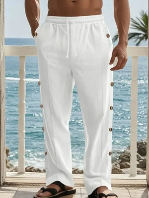 White linen palazzo trousers with side buttons and drawstring waist.