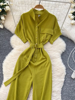 Green belted wide leg romper with short sleeves, button-down front, and a cinched waist.