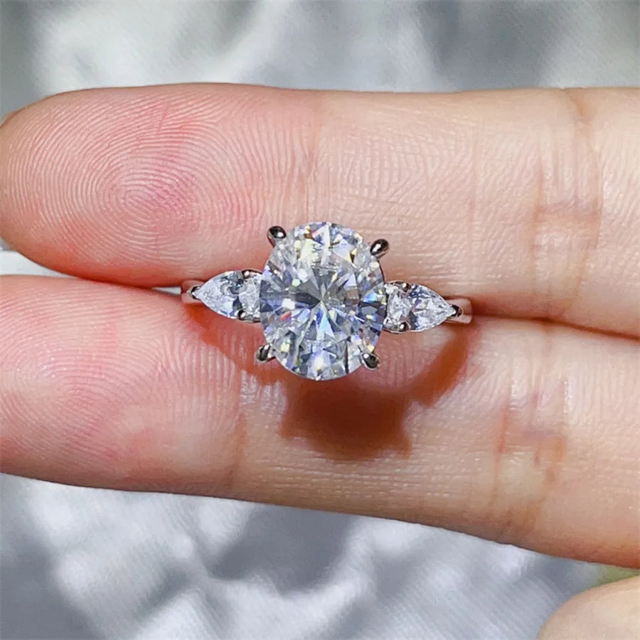 Platinum-plated, 925 sterling silver, Moissanite, Zircon (accent stones) Carat w ring in White with three-stone oval with