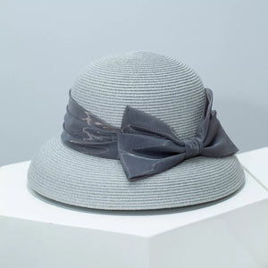 Gray straw sun hat with a large satin bow detail.
