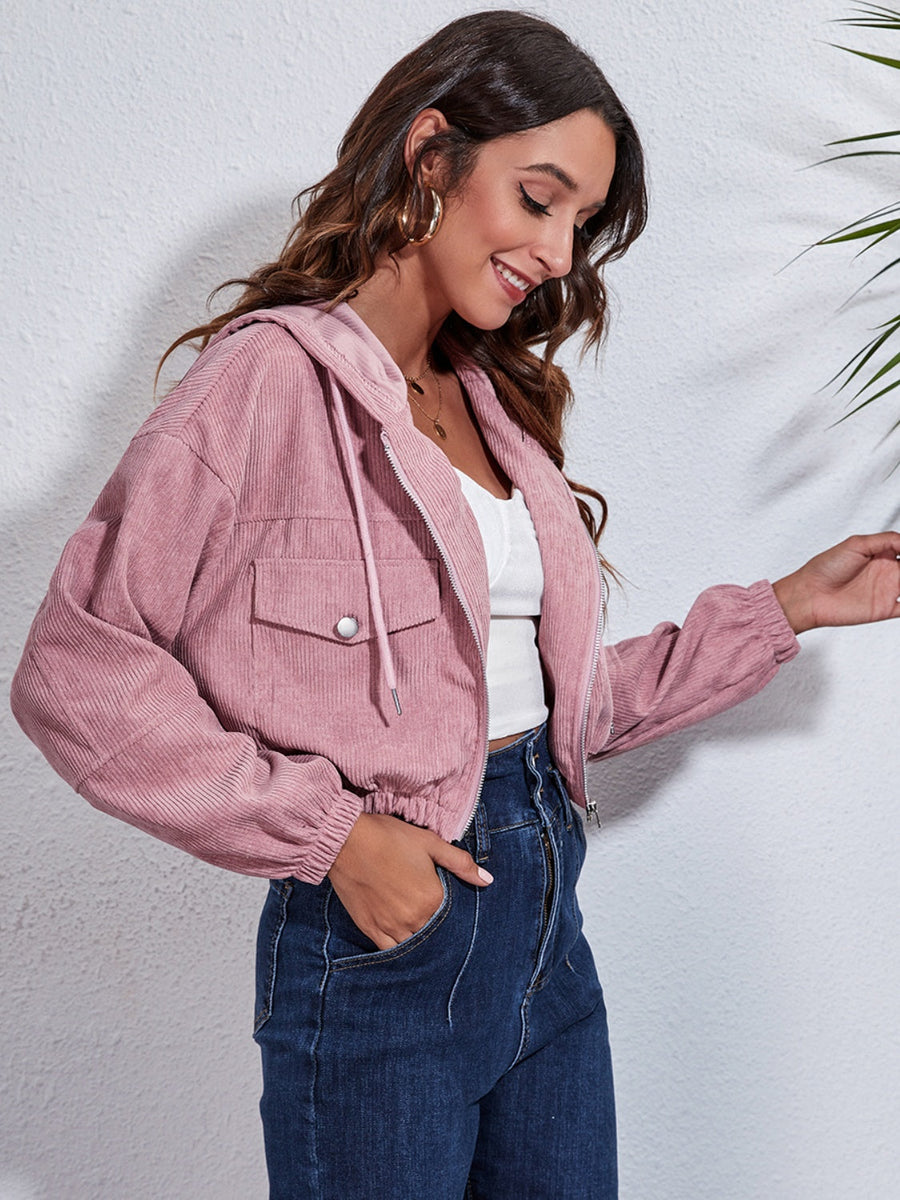 Cropped corduroy hooded jacket in blush pink with zip front and chest pockets.