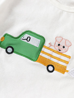 White cotton baby tee with embroidered green truck and pig detail