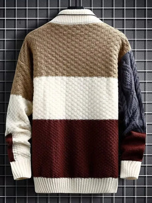 Men's color block cable-knit pullover sweater with textured panels and ribbed collar.