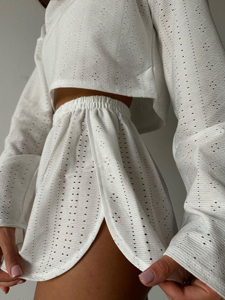 White perforated crop top and shorts set with elastic waist shorts and bell sleeves.