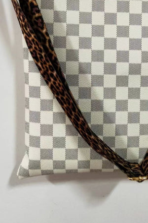 Cream crossbody bag with leopard print strap and checkered pattern