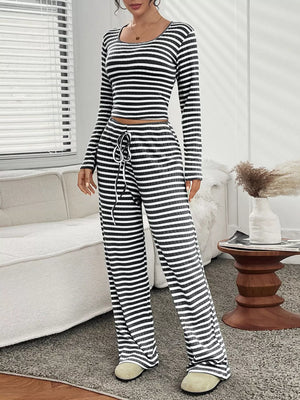 Black striped loungewear set with long sleeve crop top and drawstring pants.