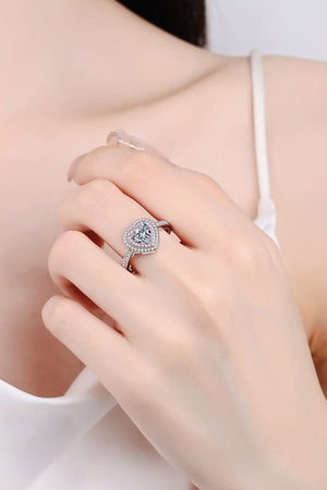 Sterling silver ring with a heart-shaped moissanite center stone and a halo of small stones.