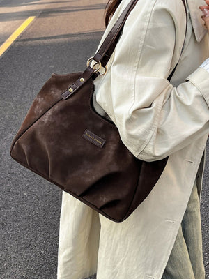 handbag in dark brown featuring shoulder strap and soft fit