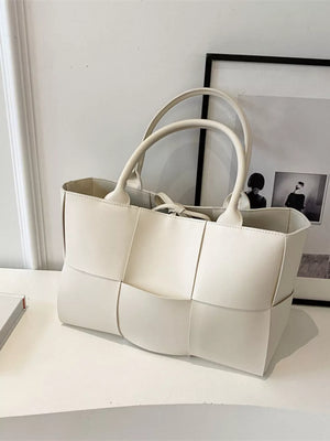 Creamy-white woven pu leather large tote bag with top handles and a tie closure.