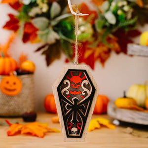 Spooky coffin ornament with skull and cross design, wood and black finish, red accents