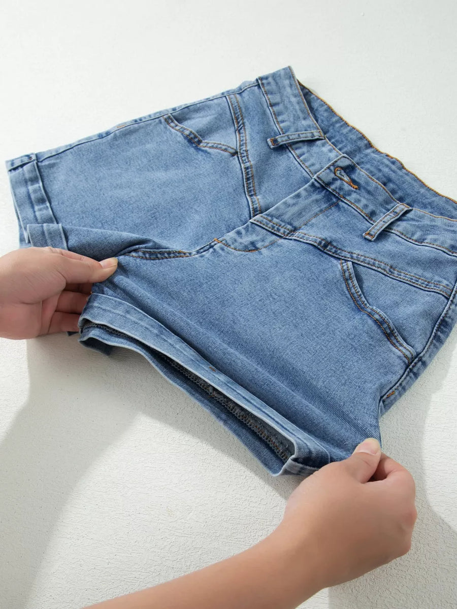 Light blue cotton denim shorts with cuffed hems and button closure.