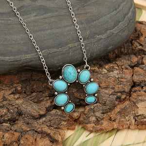Turquoise horseshoe necklace with silver chain and alloy setting.