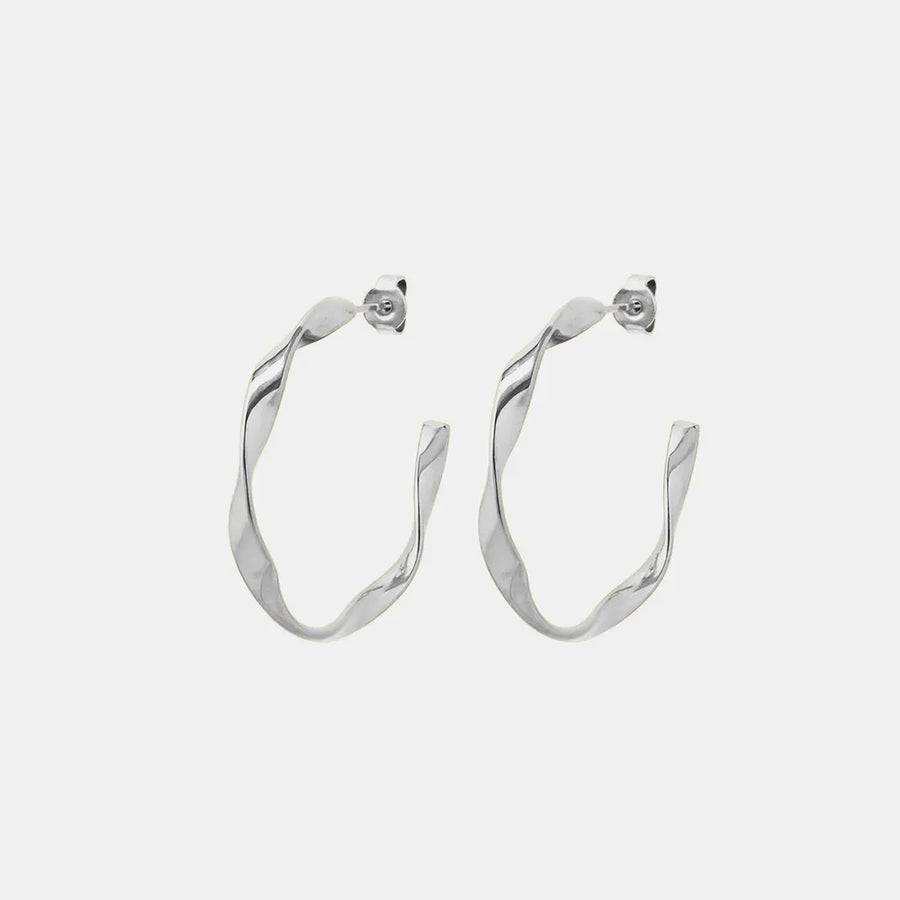 Sculpted silver twist hoop earrings with a modern, chic design.