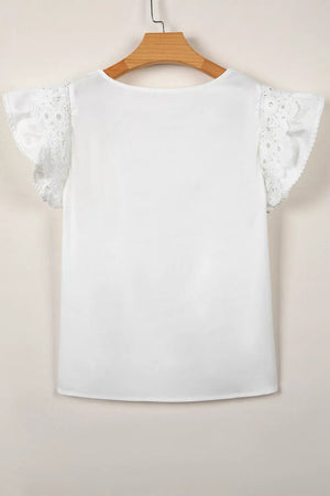 White cotton shirt with lace flutter sleeves and ruffled trim.
