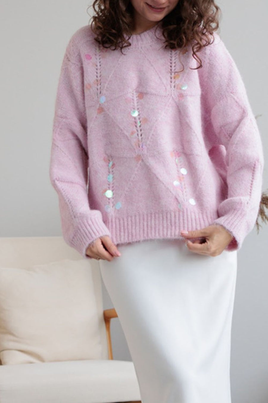 Blush pink diamond knit sweater with scattered iridescent sequins and openwork details.