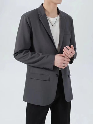 Men's dark gray classic fit sport jacket with button closure and flap pockets.