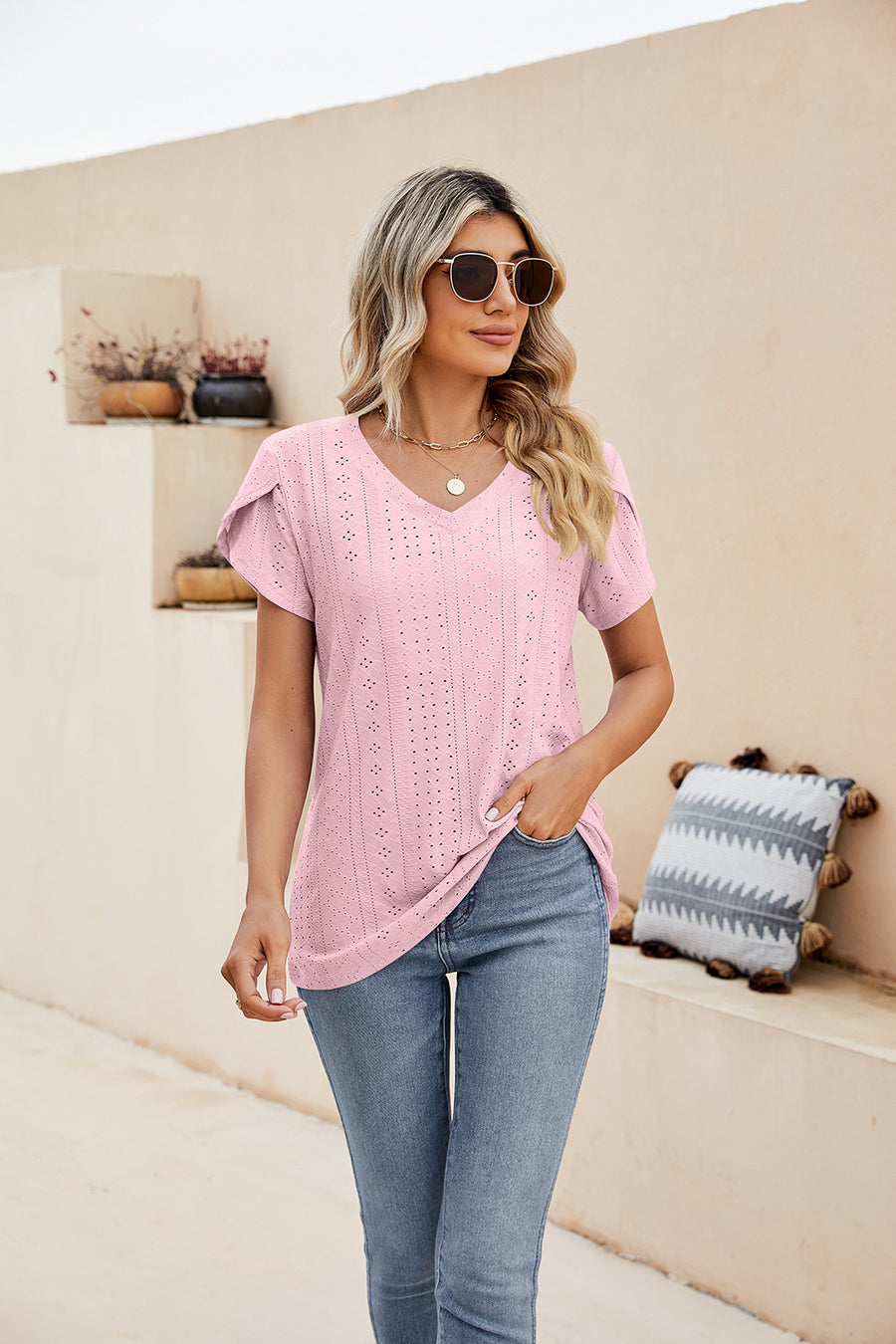 Blush pink knit top with perforated sleeve detail and v-neck