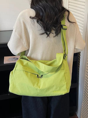 Lime green messenger bag with adjustable strap and zip closure.