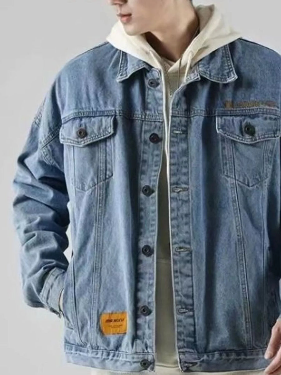 Men's blue denim trucker jacket with button-up front and chest pockets.