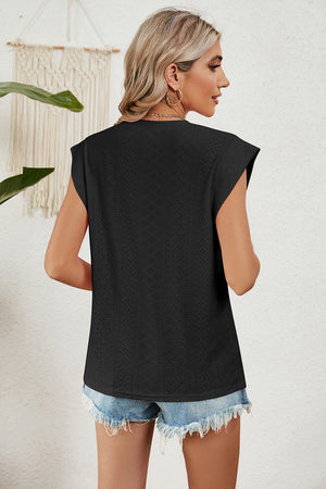 Black perforated shoulder-pad top with cap sleeves and a textured pattern.