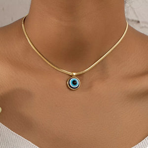 gold necklace with evil eye motif and n/a