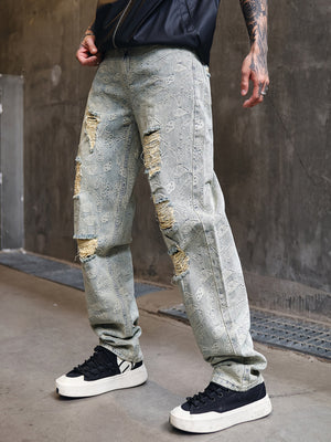 Distressed wide-leg men's jeans with paisley pattern and ripped details