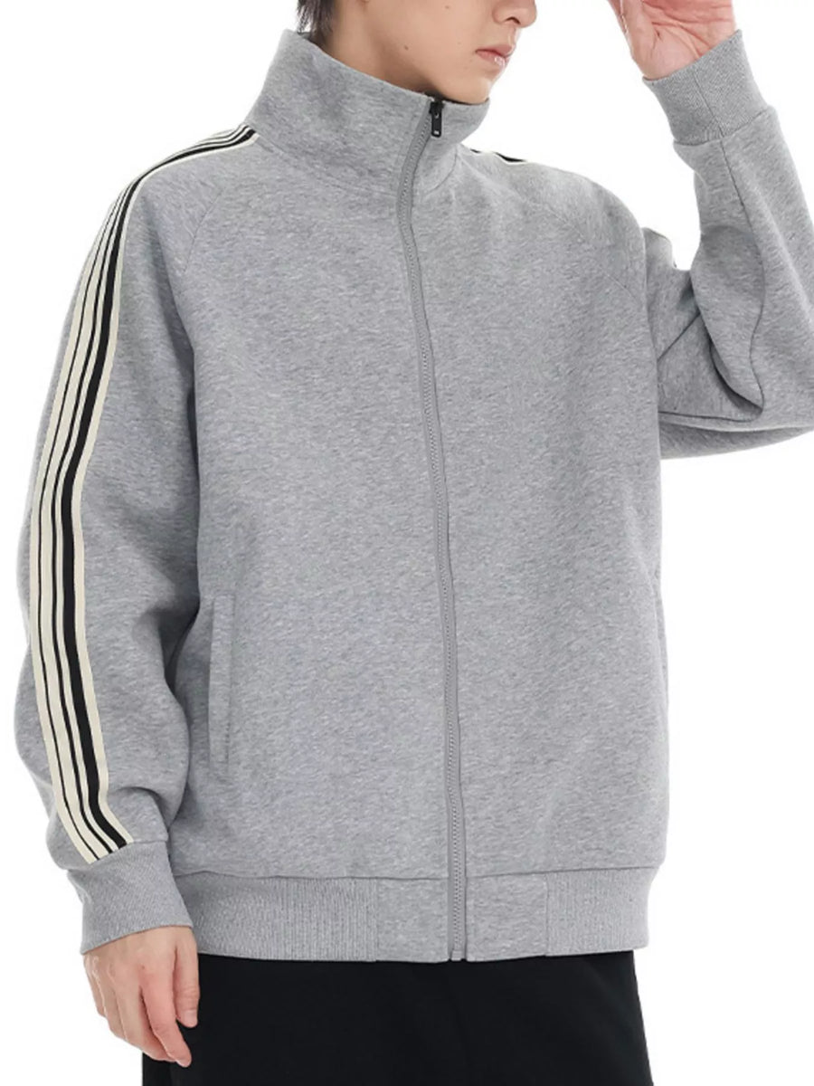 Plus-size grey zip-up sweatshirt with contrast stripe detail on sleeves and mock neck.