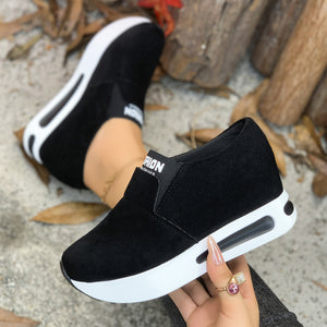 Black round toe platform slip-on sneakers with white soles and a visible air cushion detail.