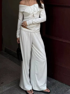 off-shoulder top and wide-leg pants set in ivory featuring frill and wide-leg fit