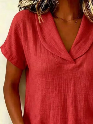 Red textured blouse with short sleeves and a V-neck collar.