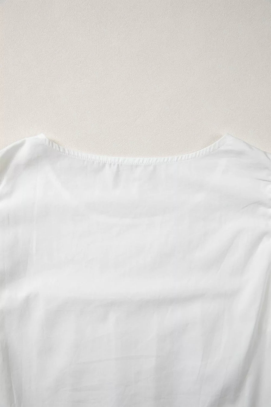 White cotton shirt with lace flutter sleeves and pleated detail