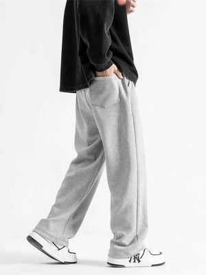 Light gray cotton sweatpants with a relaxed fit, wide leg, and drawstring waist.