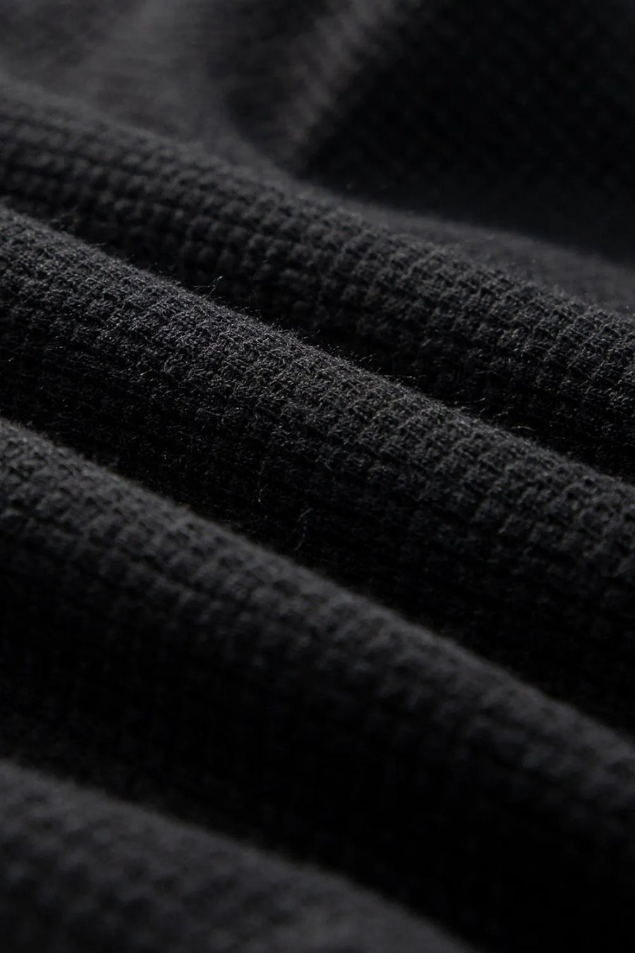 Black waffle knit jumpsuit detail showing texture