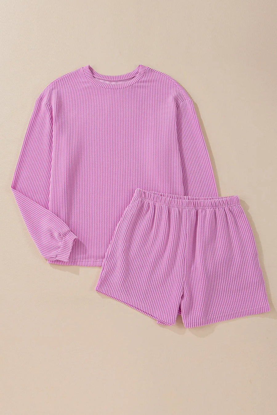 Ribbed knit matching set with crewneck long sleeve top and elastic waist shorts in pink.