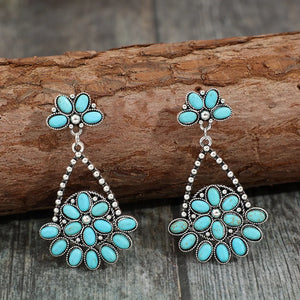 Southwestern turquoise floral dangle earrings in silver with beaded detail.