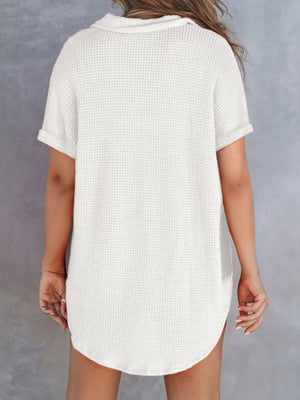 White waffle knit button-up shirt with cuffed short sleeves and curved hem.