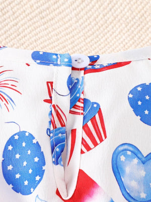 Baby one-piece with patriotic print, featuring cupcakes and fireworks, white cotton with red and blue details.