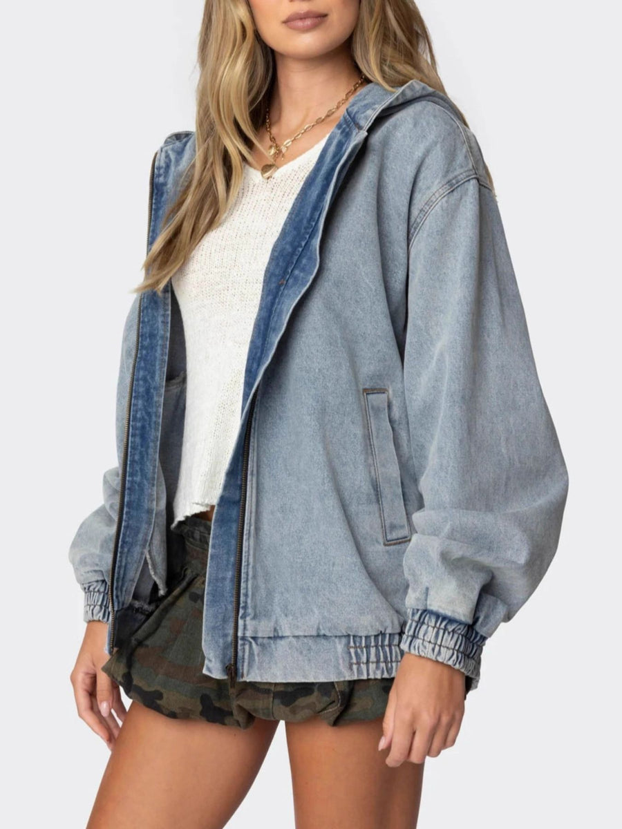 Light wash denim hooded jacket with elastic cuffs and hem, front zipper, and side pockets.