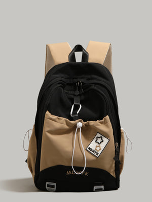 Nylon drawstring backpack in black and cream with front pocket and star patch detail.