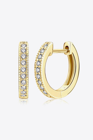 Gold pave-set huggie hoop earrings with clear stones and textured edges.