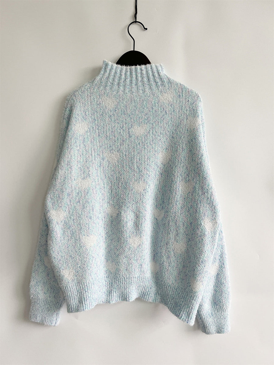Mint blue acrylic turtleneck sweater with allover white heart motif and textured knit.