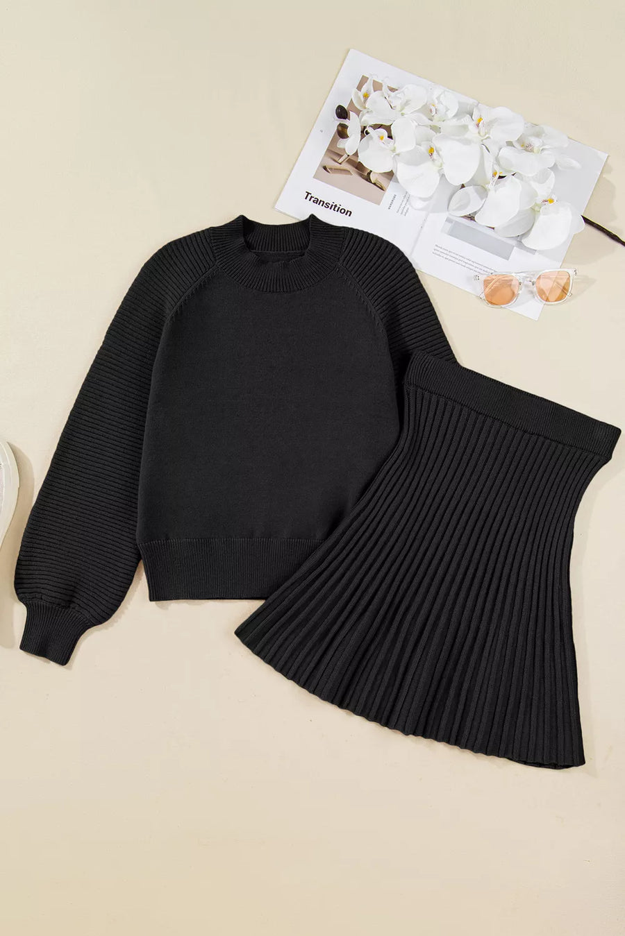 Black acrylic knit sweater set with balloon sleeves and a pleated skirt