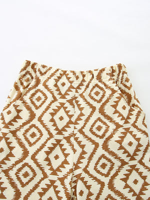 Baby shorts with elastic waist and brown diamond pattern on cream cotton.