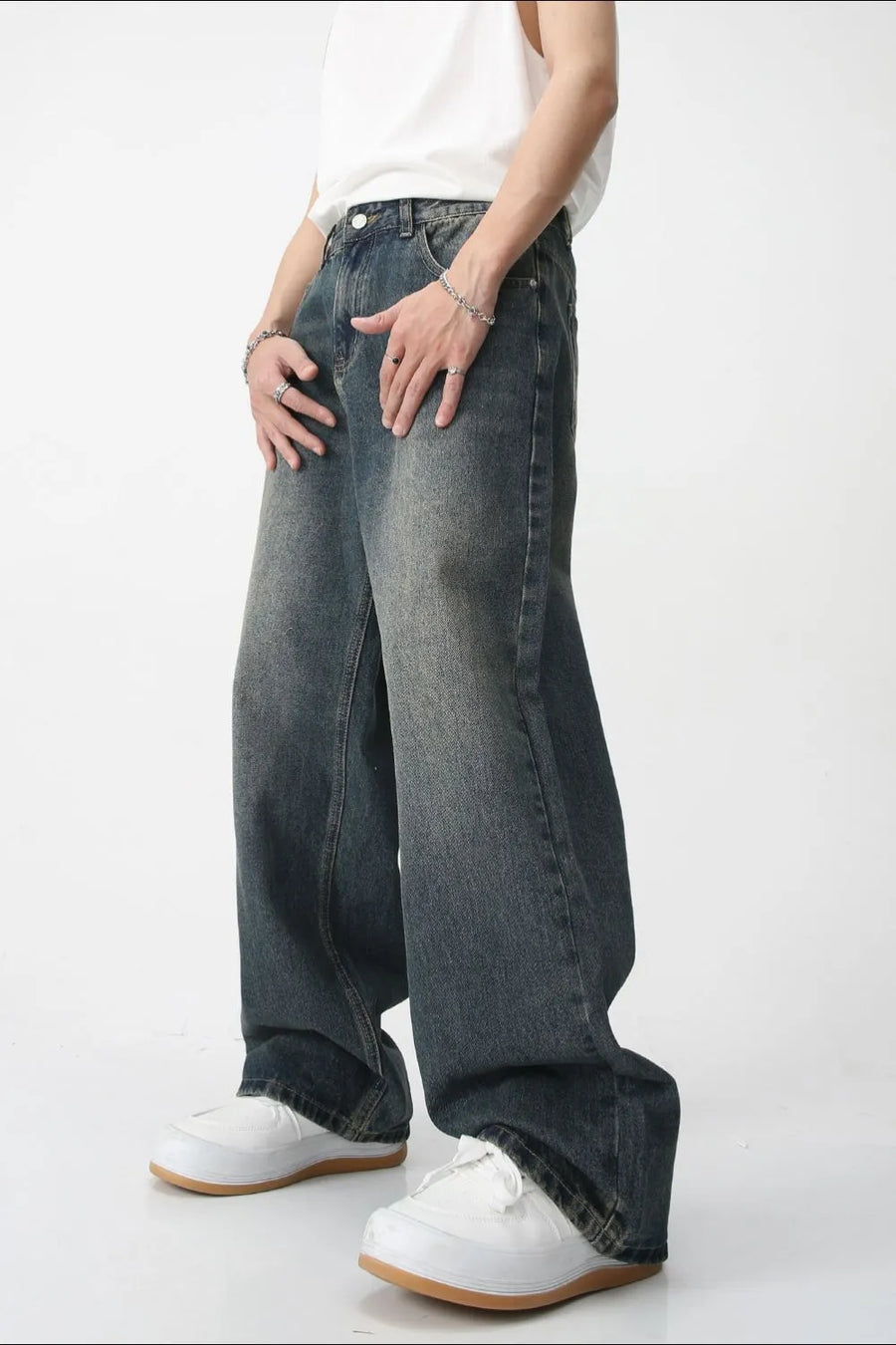 Relaxed fit denim trucker jacket in medium wash, featuring pockets and a casual style.